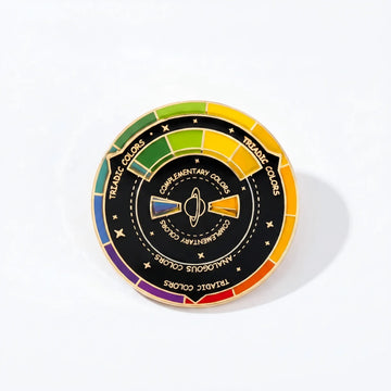 Rotating artist color wheel enamel pin on a Tiny Relics backing card