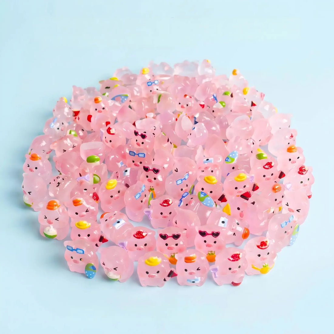 Assorted translucent pink pig figures with colorful hats, glasses and accessories