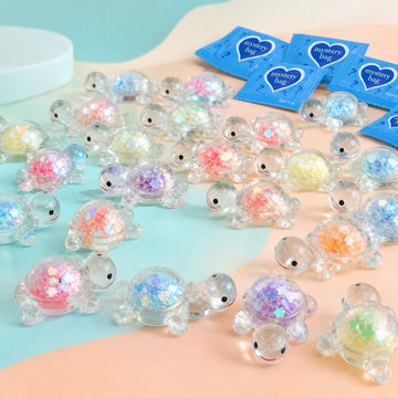 Large assortment of transparent glow-in-the-dark glitter turtle mini figurines with blue mystery bags