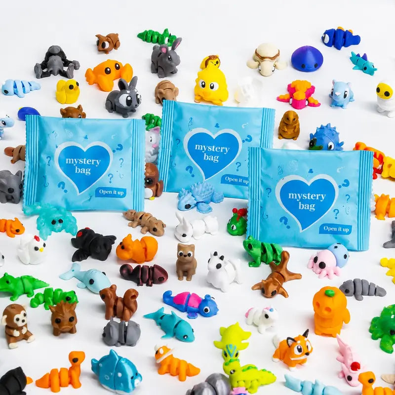 Blue mystery bags surrounded by colorful articulated animal figures