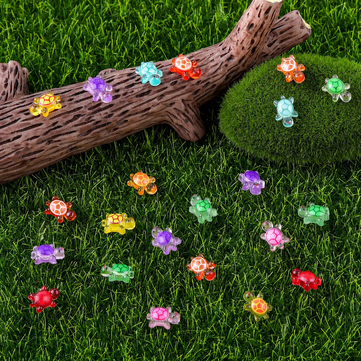 Colorful mini turtles arranged in a grass landscape